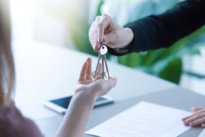 Woman getting keys to new rented own apartment, close up